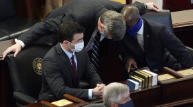 In this Jan. 13, 2021 file photo, Sen. Mike Woodard, D-Durham, speaks with Sen. Ben Clark, D-Hoke, right, and Sen. Jeff Jackson, D-Mecklenburg in the Senate chamber during the opening session of the North Carolina General Assembly in Raleigh, N.C. Jackson has announced he is running for the U.S. Senate in 2022. Jackson unveiled his bid on Tuesday, Jan, 26, 2021.