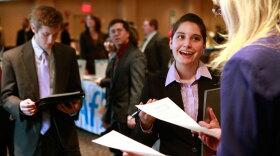 Stephanie Buckley, of Boston (second from right), has her resume reviewed by Shelly Piper, of Cape Ann, Mass. (right), at the BostonHires job fair in a hotel in Boston, Tuesday.