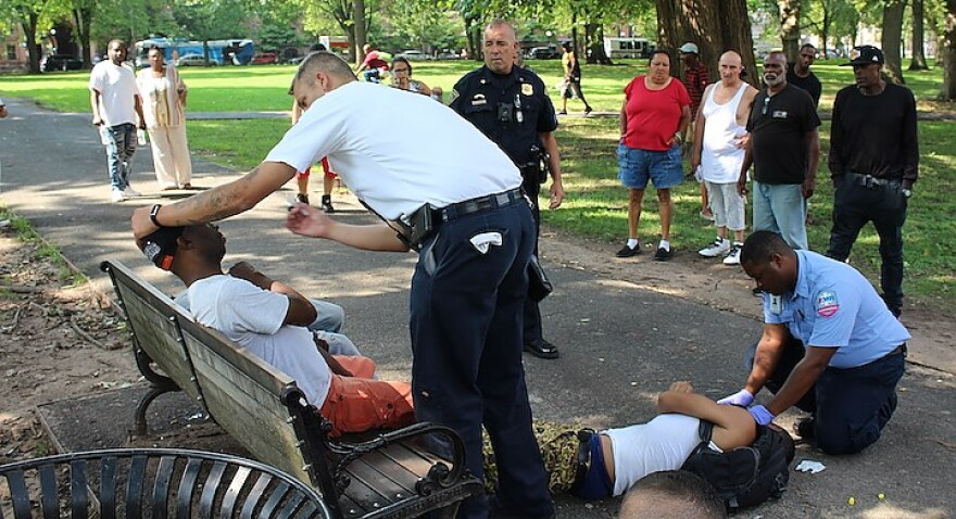 First responders seek to revive victims passed out on the Upper Green mid-afternoon on Wednesday.