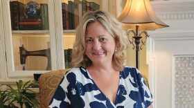 B. Elizabeth Beck sitting in chair facing camera