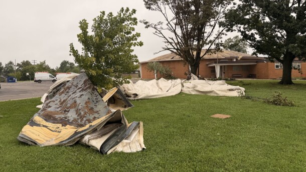 The metal roof of the Barack Community Center lays on the ground on August 12, 2026, wrapped around trees and crumbled like a plastic tarp following severe storms in central Ohio.