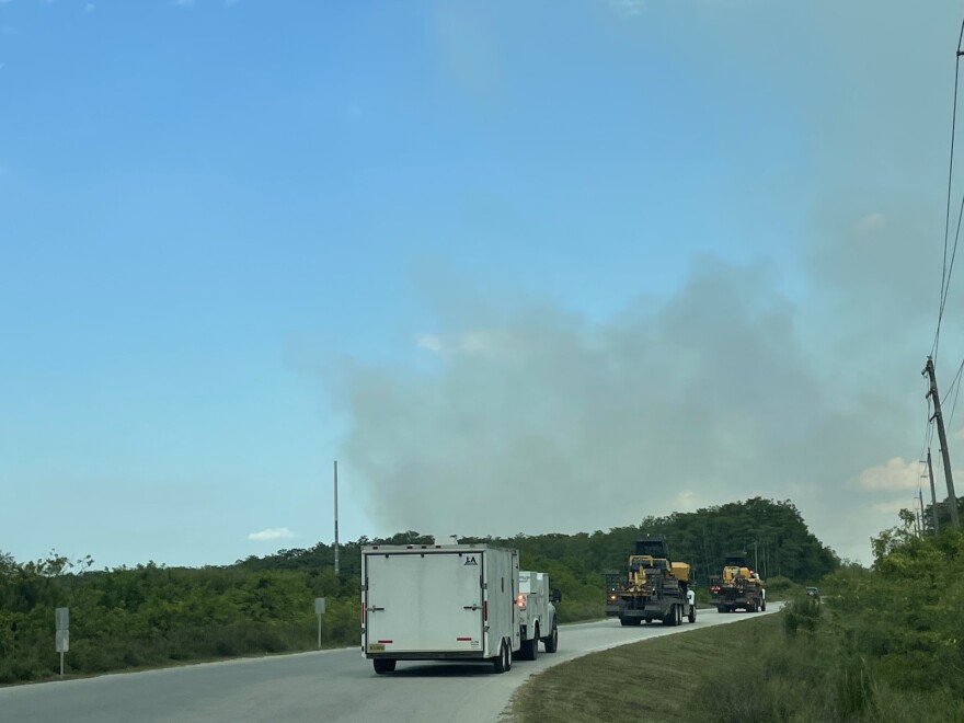 A tractor plow crew from the Florida Forestry Service Caloosahatchee Office drive toward a 40-acre wildfire off Green Meadow Road in eastern Lee County Friday afternoon.