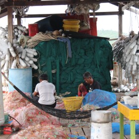 Workers clean out bycatch from nets on a dock in Koh Sdach, an island in Cambodia’s Koh Kong province. Illegal fishing threatens traditional fishing villages and marine ecosystems in Cambodia. Artificial reefs are being used to fight back.