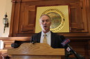 New Bedford Mayor Jon Mitchell gives a speech at a podium.