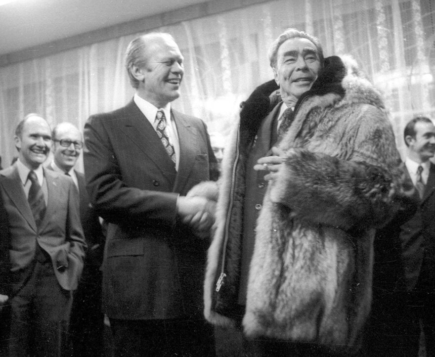 President Gerald Ford greets Brezhnev in 1974 after the Soviet leader tried on Ford's fur coat at a summit in what's now Vladivostok, Russia.