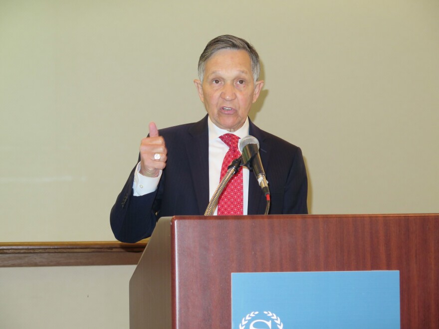 form U.S. Rep. Dennis Kucinich stands at a podium 