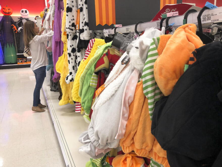 A customer looks through kids Halloween costumes at a Target department store on Tuesday, Oct. 2, 2018, in Aventura, Fla. (Brynn Anderson/AP)