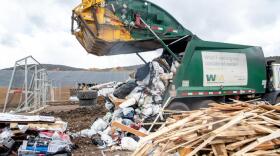 A Waste Management truck loads trash into the Pitkin County Solid Waste Center’s new location for trash on Tuesday. County staff presented an update on the project’s budget to the Pitkin Board of County Commissioners during a work session on Tuesday.