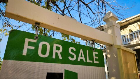 A For Sale sign pitched out in front of a Salt Lake City home, July 23, 2026.