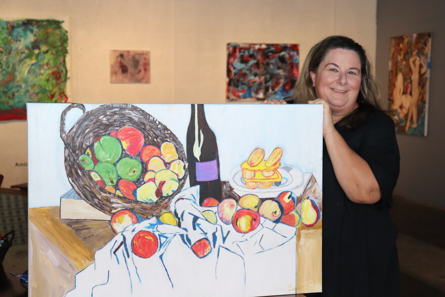 Beth Siebert with one of her paintings