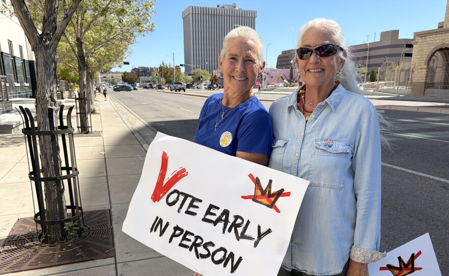 Michelle Schofield (L) and Rosa Weiss (R) holding signs on Lomas Wednesday October 7, 2026 on the first day of early voting for the general election on November 3, 2026.