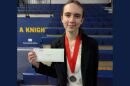 Genevieve Laguna posing with her medal and award at the National History Day's state contest.
