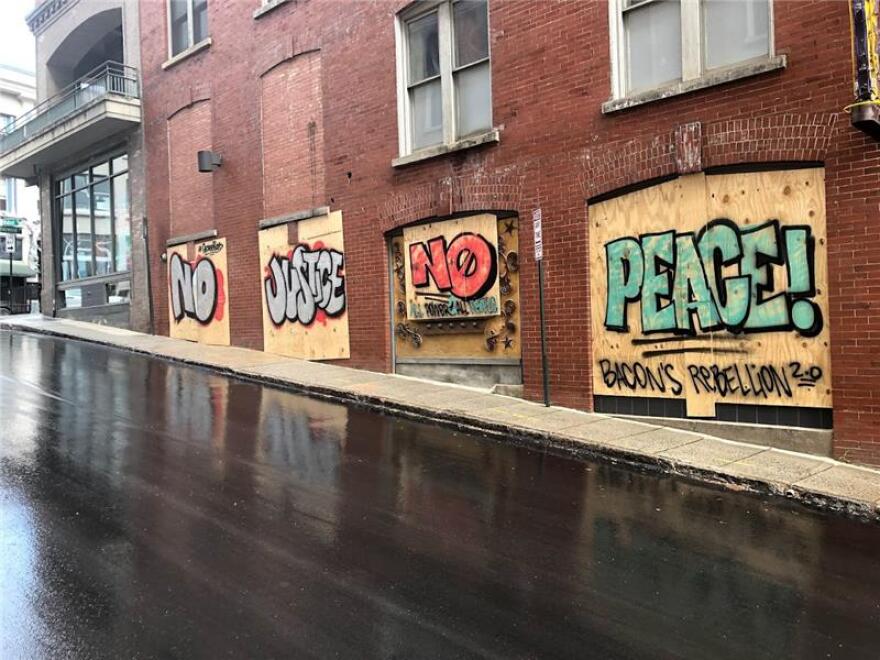 Graffiti dedicated to social justice peppers the boarded-up walls of Walnut Street in downtown Asheville.