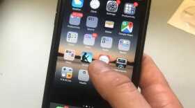 A person holds an iphone