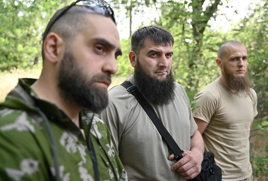 Members of the volunteer Sheikh Mansur Battalion (from left) Islam, Mansur and Asadulla speak to an AFP journalist during an interview in Zaporizhzhia on June 9. The Sheikh Mansur Battalion was founded in 2014 after the annexation of Crimea and composed mainly of Chechen veterans. The group was named after a Chechen military commander against Russian expansion in the Caucasus in the 18th century.