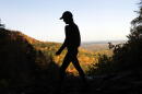 A hiker takes in the fall colors as she makes her way along the Indian Ladder Trail at John Boyd Thacher State Park on Tuesday, Oct. 18, 2016, in Voorheesville, N.Y. (Mike Groll/AP)