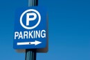 Blue parking sign against a blue sky.