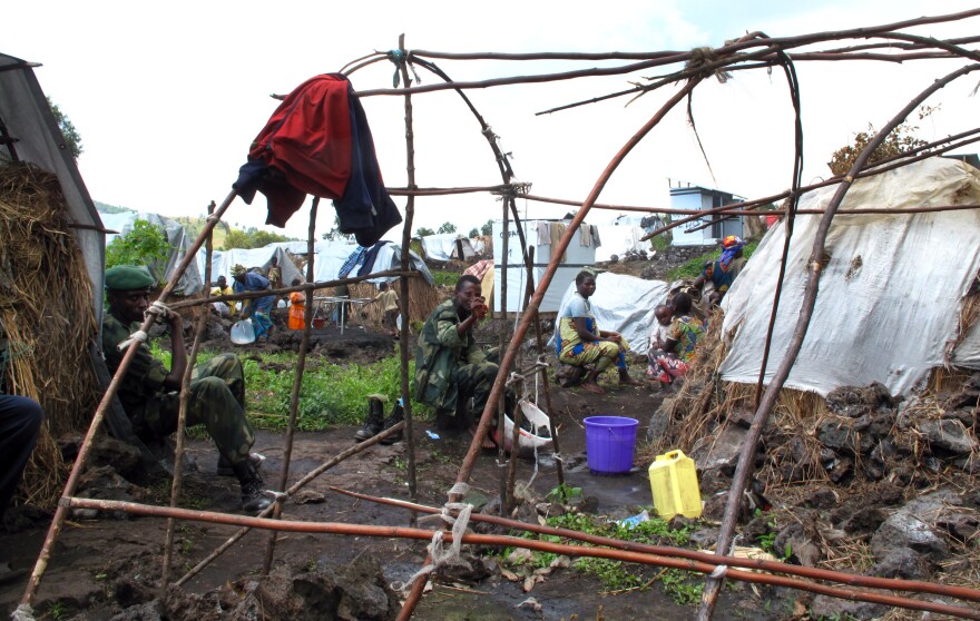 Mugunga I is a camp of approximately 60,000 displaced people, mostly women and children. Here, soldiers from the Congolese army — who are not supposed to be in the camp — use camp water provided by Oxfam on Dec 19.