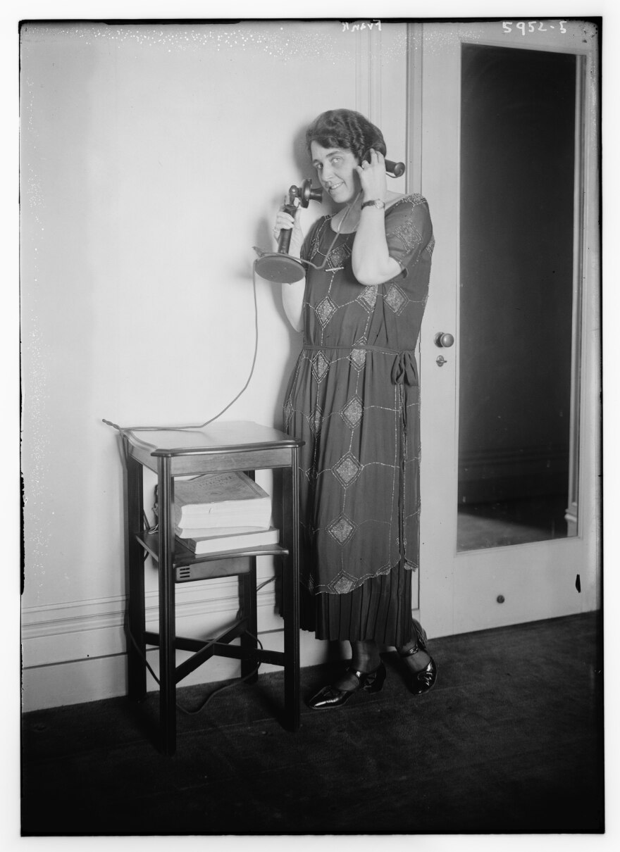vintage photo from 1900 of a woman answering a phone