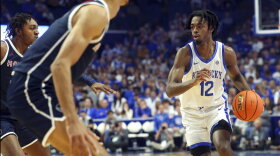 Kentucky's Antonio Reeves (12) looks for an opening on Howard's Bryce Harris, left, during the first half of an NCAA college basketball game in Lexington, Ky., Monday, Nov. 7, 2022. (AP Photo/James Crisp)