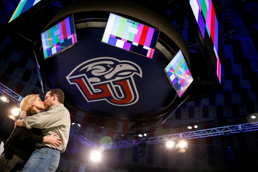 Sen. Ted Cruz kisses his wife, Heidi, during a walk-through Sunday night at Liberty University. Cruz plans to announce his presidential campaign at the school Monday.