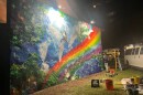 Todd "Estria" Johnson, far right, putting the final touches on the latest mural at the Lutheran Church of Honolulu. (May 2026)