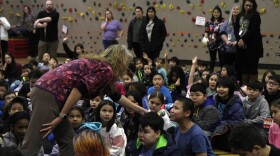 Alaska Native Cultural Charter School Principal Sheila Sweetsir asks a student a question during the morning assembly on Feb. 20, 2024.