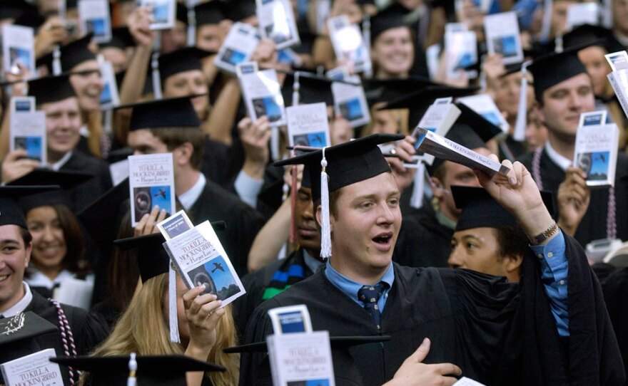 Notre Dame students hold up copies of <em>To Kill a Mockingbird</em> during commencement ceremonies in May 2006 -- during which the university awarded Harper Lee an honorary degree.
