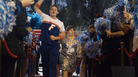 A University of Florida cheerleader pumps up the crowd as he escorts his guest down the red carpet at this year's Night to Shine, which was held at Westside Baptist Church on Friday, Feb. 6, 2026.