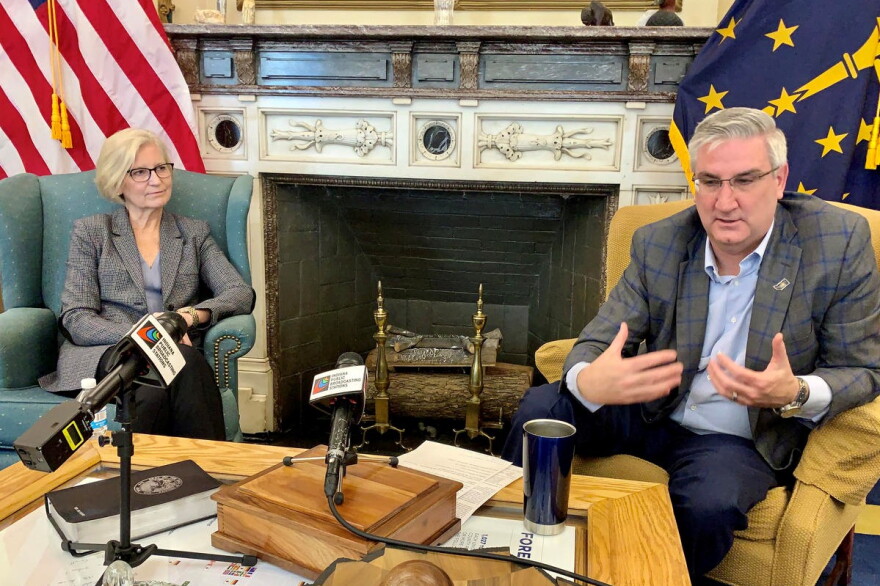 Indiana Health Commissioner Dr. Kris Box, left, and Gov. Eric Holcomb discuss the state's response to COVID-19.