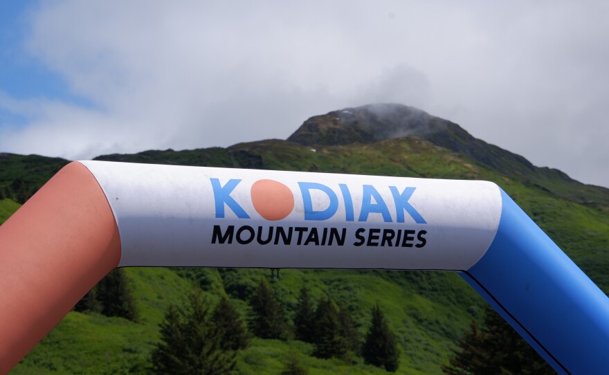 The top of Pyramid can just be seen poking out of the clouds behind the Kodiak Mountain Series arch on June 21.