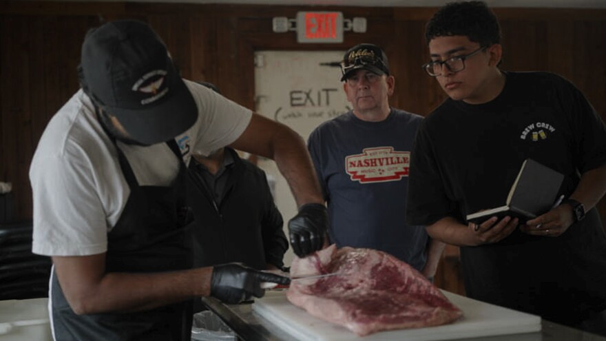 Goldee’s co-owner Zain Shafi demonstrates how to trim a brisket during one of the restaurant’s brisket classes. Shafi started his journey with Goldee’s as a student, before going out on his own and later returning to Goldee’s as an owner.