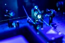 Laser reflects on optic table in quantum laboratory.