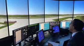 State University of New York (SUNY) Chancellor John King tests out SUNY Schenectady's new air traffic control tower simulator, which is an animation of a runway found at the Federal Aviation Administration academy in Oklahoma City. The Schenectady college built the simulator as part of its new and upcoming expedited training program for future air traffic controllers.