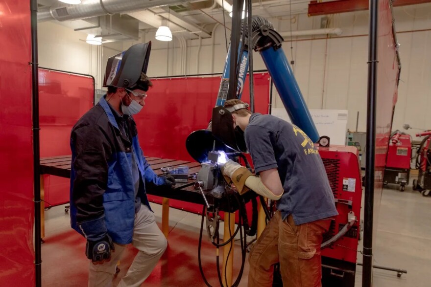 Charles Morrison, 17, junior, left, watches Talyn Walsh, 16, junior, TIG welding at Ella T. Grasso Technical High School.