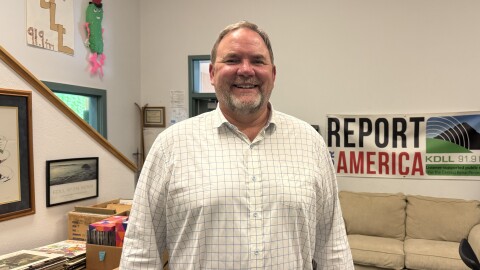 Clayton Holland stands in the KDLL studio on Monday, June 9, 2025 in Kenai, Alaska.