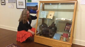 Executive director of the Matheson History Museum Peggy Macdonald admires artifacts of Marjorie Harris Carr. The zoologist used the leather saddle on research trips to Honduras in the 1940s.
