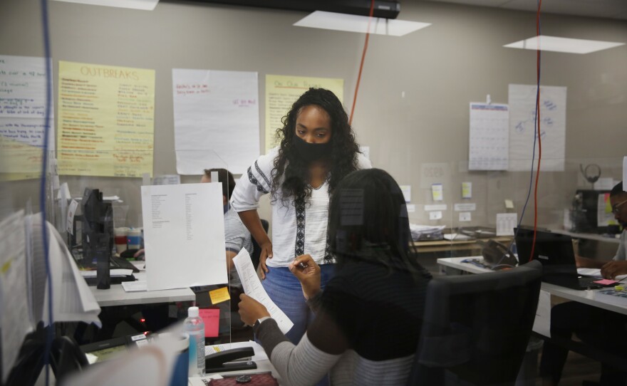 Emily Williams, a senior at the University of Illinois who's studying community health, confers with a supervisor on a case.