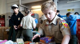 Scout Nate Thompson, 11, of Troop 21 sorts non-perishable food items for the annual Scouting for Food Good Turn drive. 