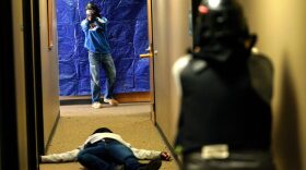 A student (R) engages a gunman overa mock shooting victim during a Tac*One Consulting "Lone Wolf" civilian active shooter response course for concealed weapons permit holders in Longmont, Colorado. 