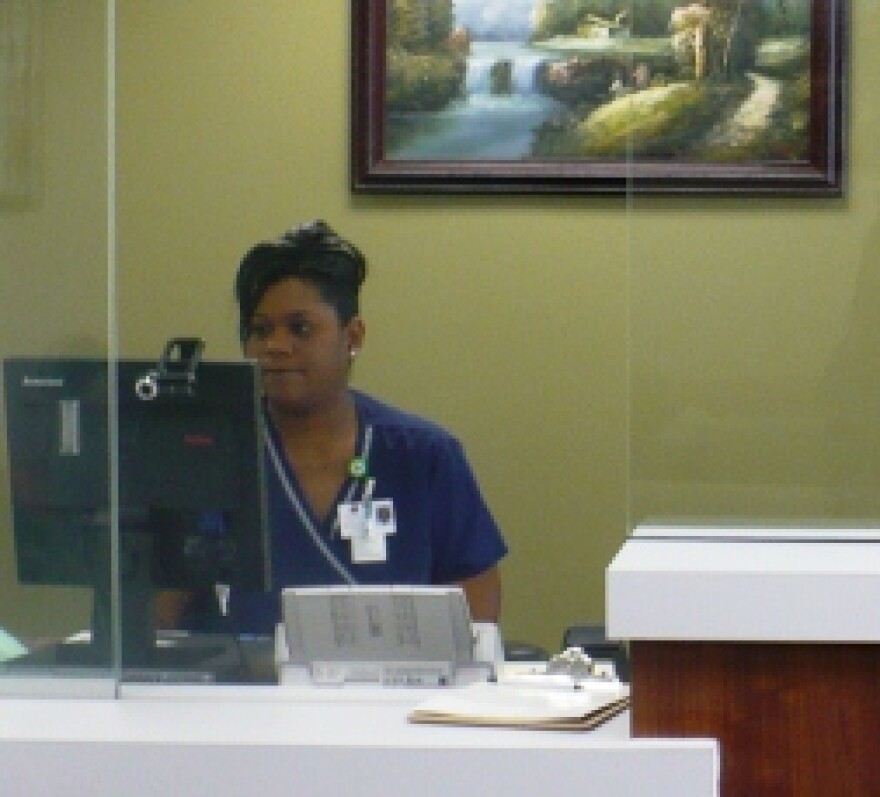 Virrinda Eferakeya checks people in for appointments at the new Swope Health South Clinic.