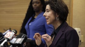 Rhode Island Gov. Gina Raimondo (right) and R.I. Director of Health Nicole Alexander-Scott (behind) face reporters during a news conference on COVID-19. (Steven Senne/AP)
