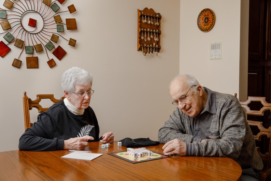 George Berzsenyi and his wife, Kay, of 54 years, play a board game on the dining room table of their Shorewood, Wis., home.