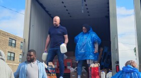 Volunteers distribute food and toiletries out of a truck in the parking lot of the Resource Council of WNY on May 16, 2022, two days after a mass shooting at the nearby Tops Market on Jefferson.