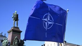 Participants wave the NATO flag at Senate Square in Helsinki, Finland after the country became the 31st member of NATO.