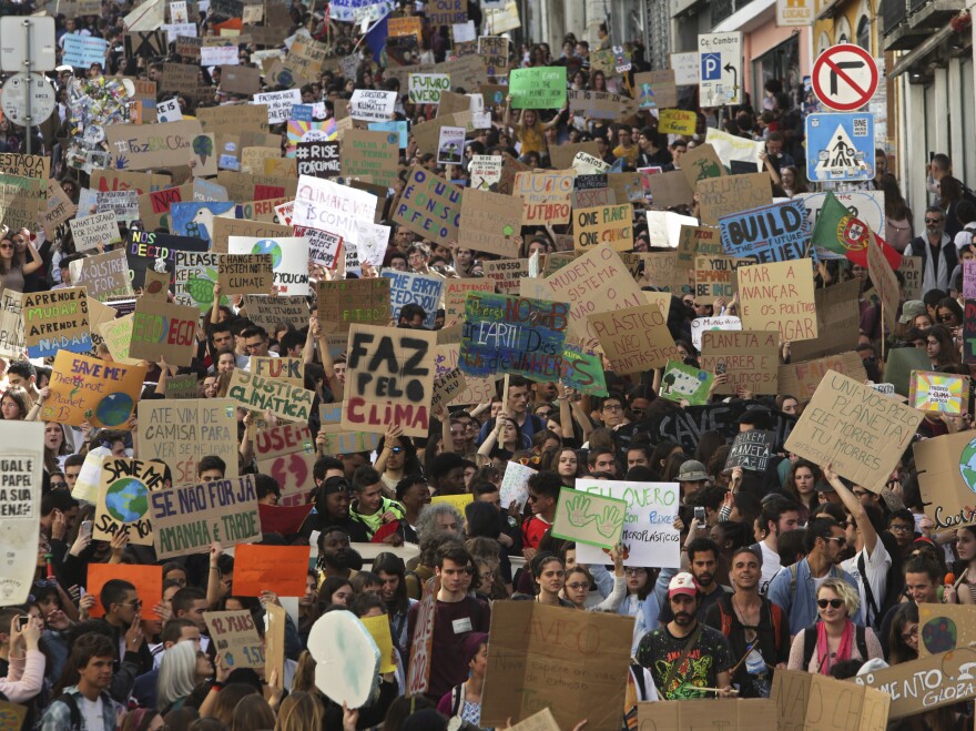 Students carry posters and chant slogans during a protest march through Lisbon, Portugal.