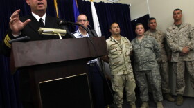Navy reservist Capt. John Murphy (L), former chief prosecutor of military commissions at Guantanamo Bay, speaks during a press conference in 2009.