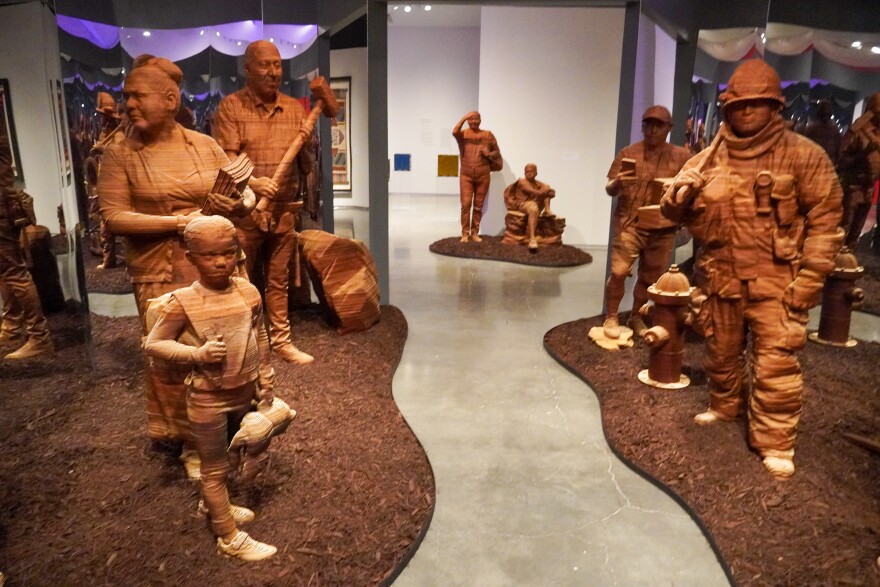 Life-sized wooden sculptures in tribute of essential workers.