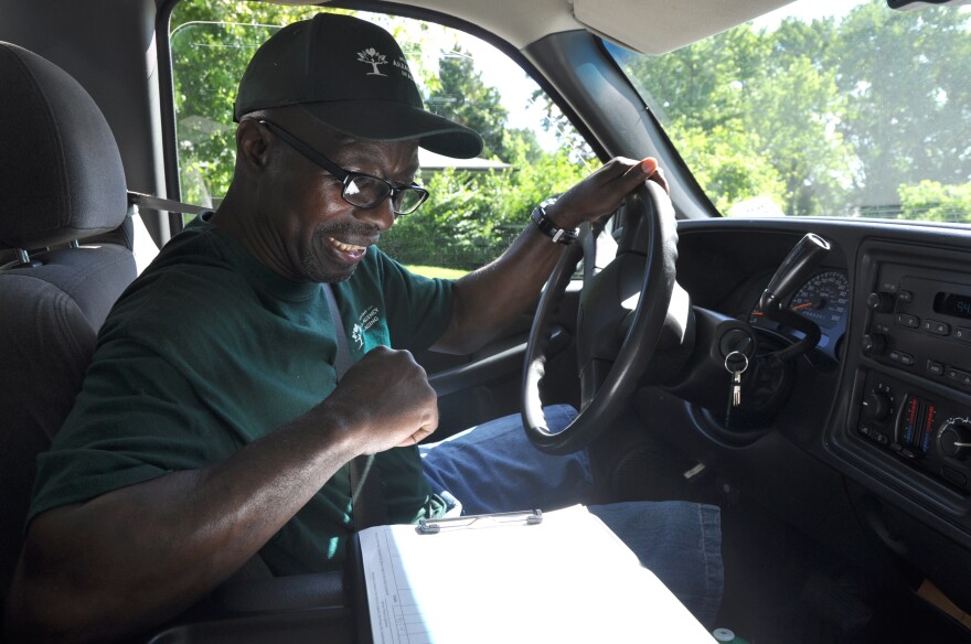 Van Tyler checks a list of names and addresses while delivering meals in Jennings for the Mid-East Area Agency on Aging in June, 2016. 