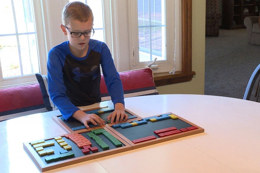 Grant Hartley works with his mom before school every day to improve his reading skills through a special tutoring program.